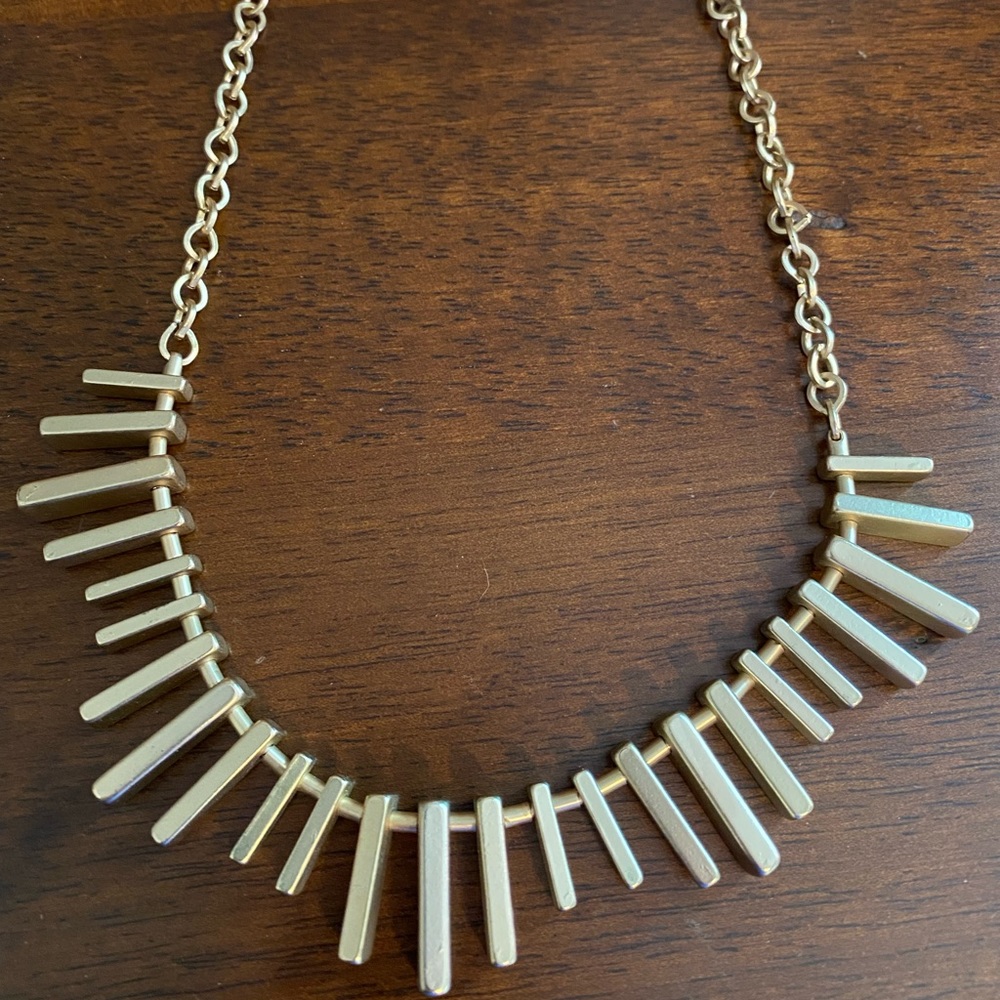 Bold Gold colored BR necklace.